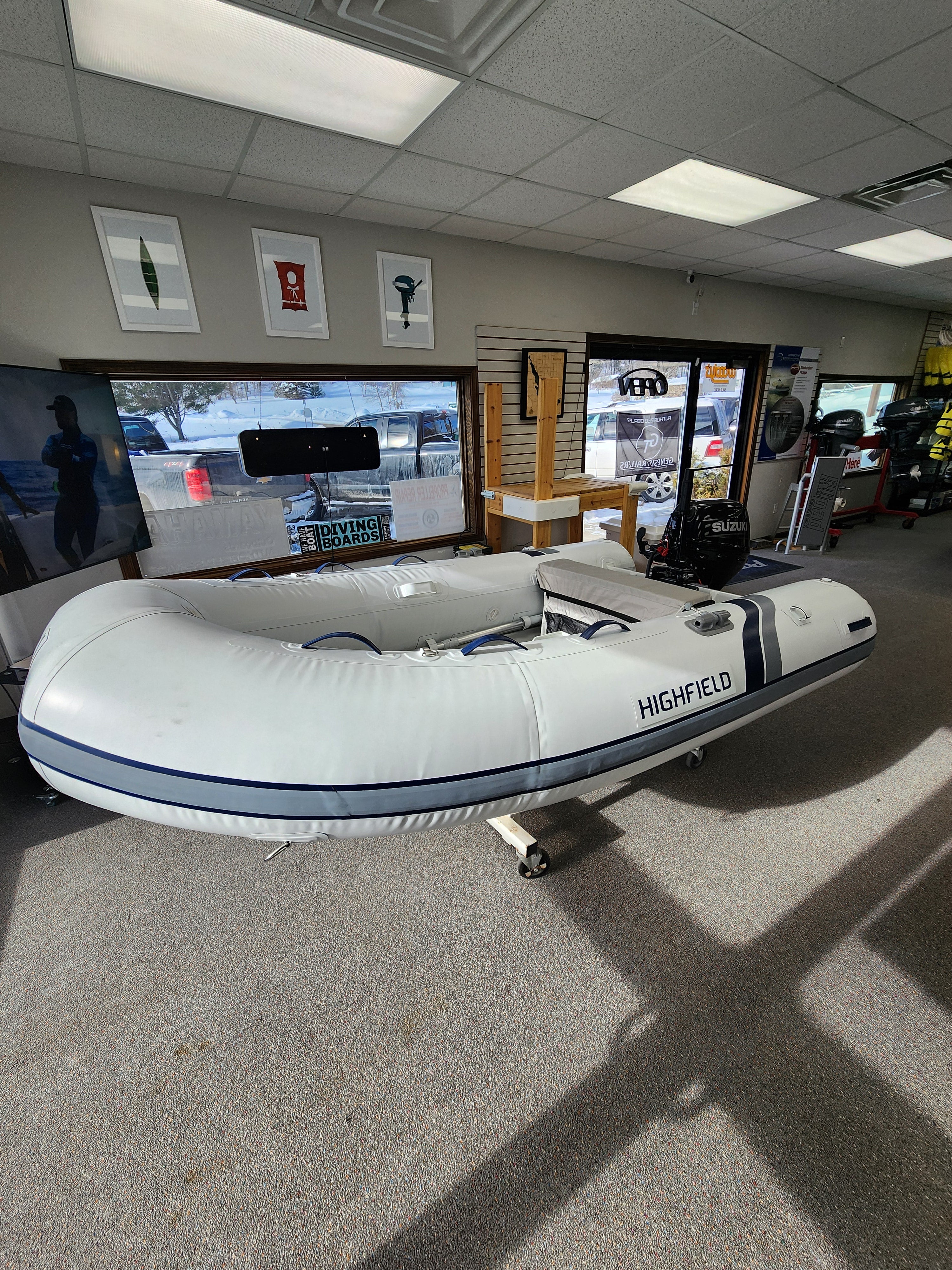 Inflatable boat with Suzuki motor on display in a showroom RIB Highfield Dinghy UL290 2025