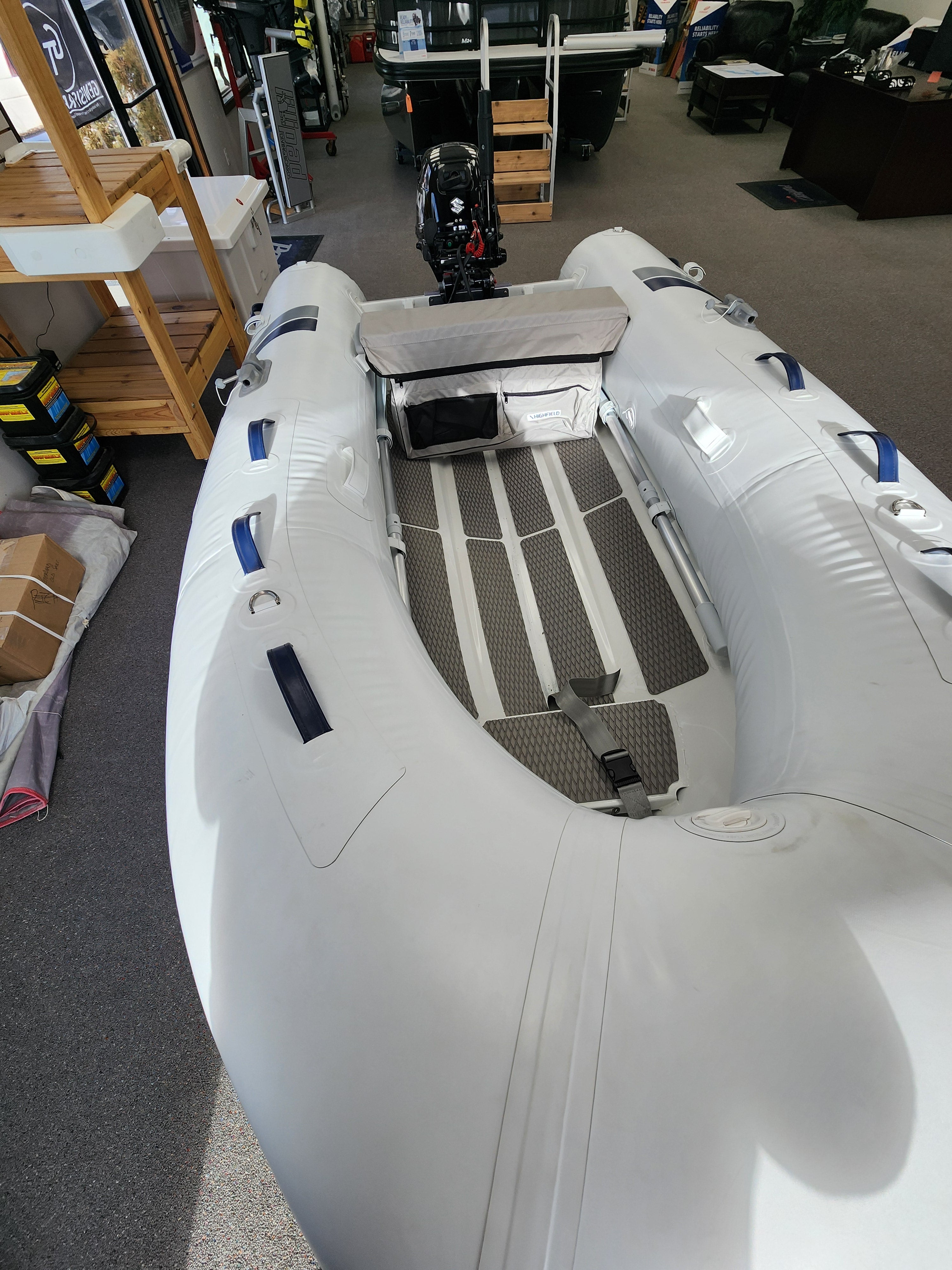 Inflatable boat with Suzuki motor on display in a showroom RIB Highfield Dinghy UL290 2025